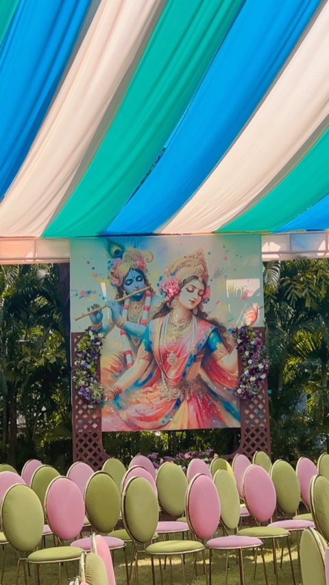 Themed backdrop and pastel seating for a cultural function on the lawn
