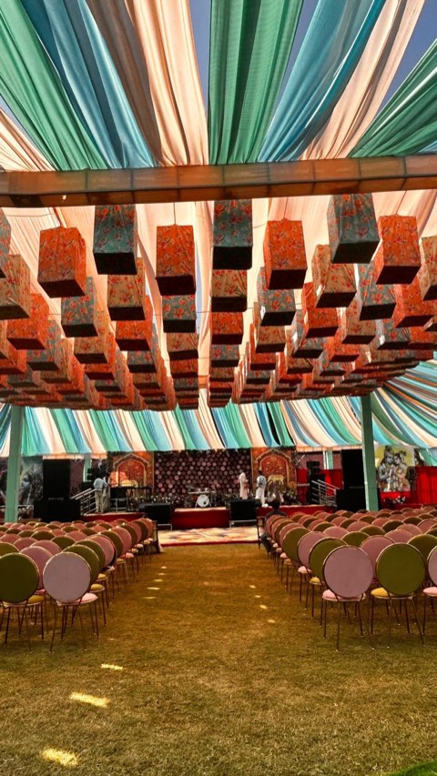 Colourful draped canopy with hanging box decor for an outdoor family function