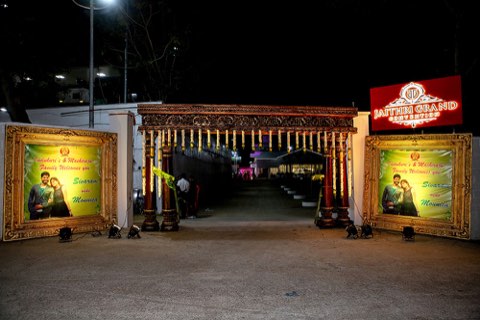 Traditional entrance arch with banana-leaf decor at night