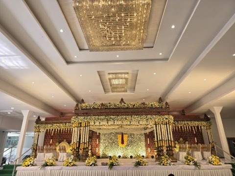 Hall 1 – air-conditioned main hall with yellow floral mandap and chandeliers at Jaithri Grand, Shamshabad